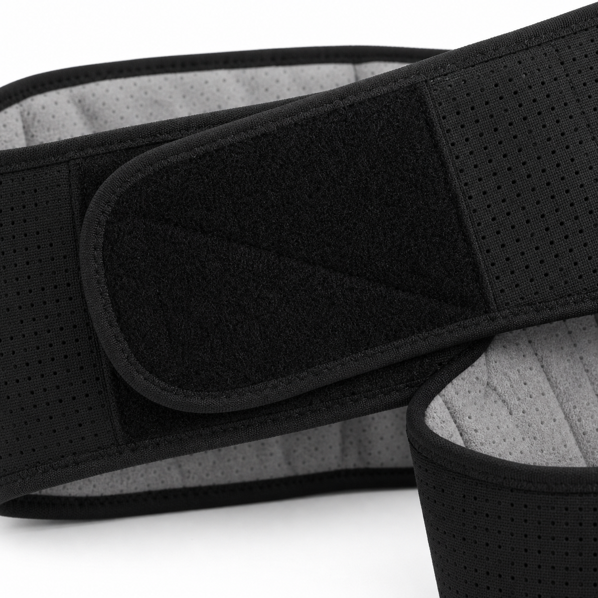 Close-up detail of the DriveOn CoreRelief belt closure flap, showing the mesh outer shell and grey inner lining